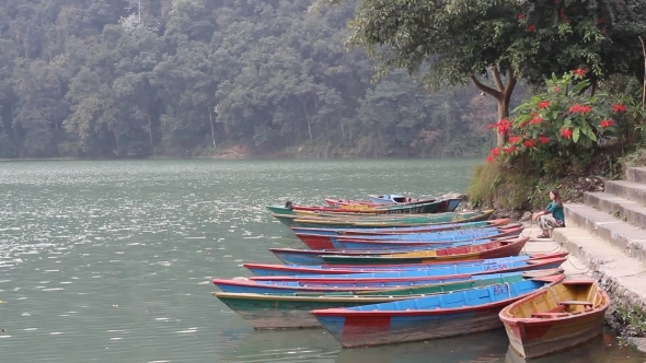 European Woman Sitting On The Pier In Nepal