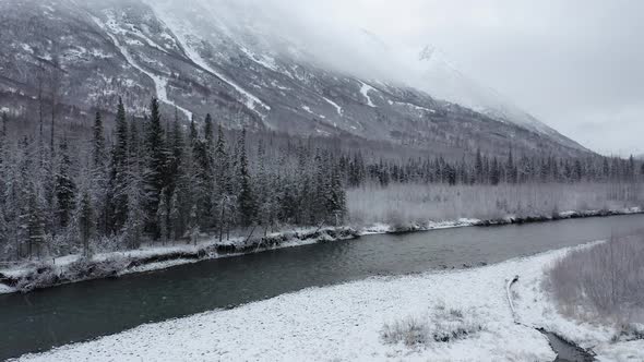 Drone gains altitude over Alaska River.