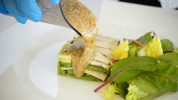 Chef Removing Mold in a Tartar Made of Fish and Avocado Fruit