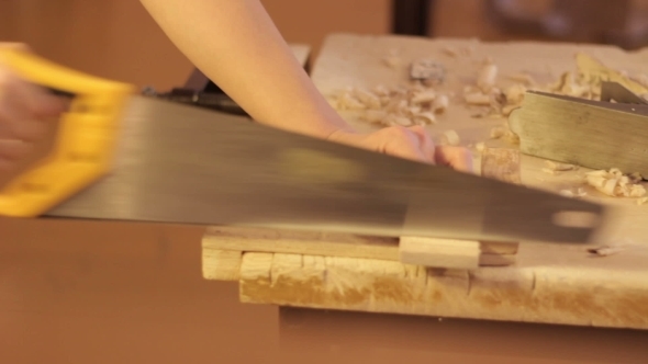 Sawing The Plank With a Hand Saw