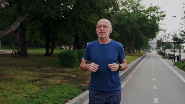 Old Male Senior Running or Jogging in Park