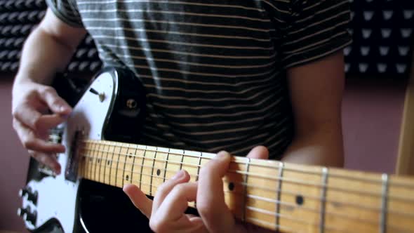 Musician Plays on Electro Guitar in the Studio