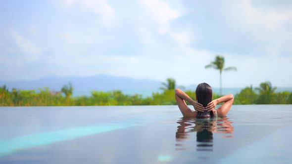 Young asian woman enjoy around outdoor swimming pool for leisure