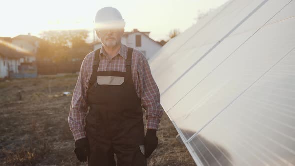 Portrait of Successful Engineer Stands at Solar Batteries with Crossed Hands