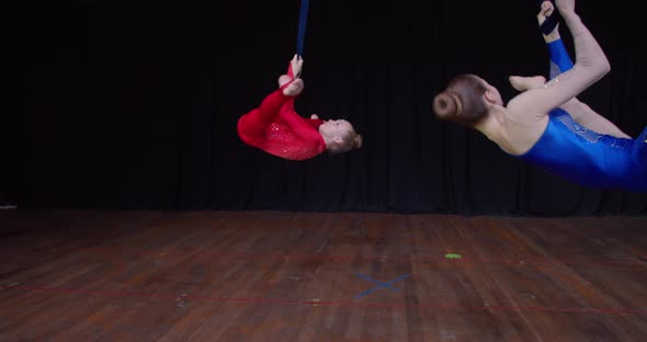 Beautiful Aerial Gymnastics Show Two Girls are Doing Tricks in the Air