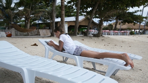 Young Girl With Tablet Pc At The Beach.