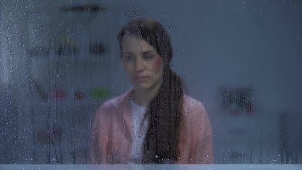 Man Putting Engagement Ring in Front of Wife With Wounded Face, Divorce, Rain