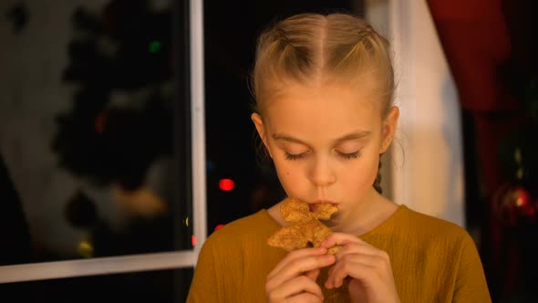 Sad Girl Eating Xmas Cookie, Standing Near Window, Orphan Charity Organization