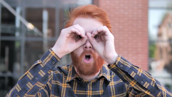 Binocular Gesture By Redhead Beard Young Man