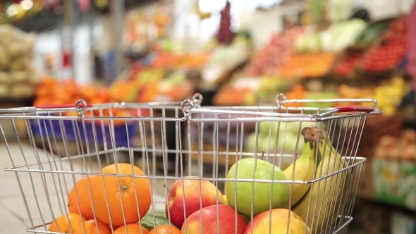 Shopping Cart With Fruit On The Background Of The Market