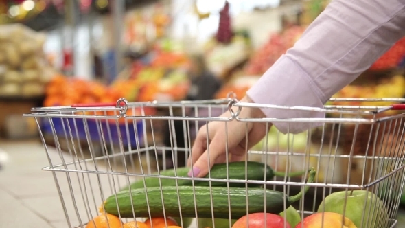 Shopping Cart With Vegetables On The Background Of The Market