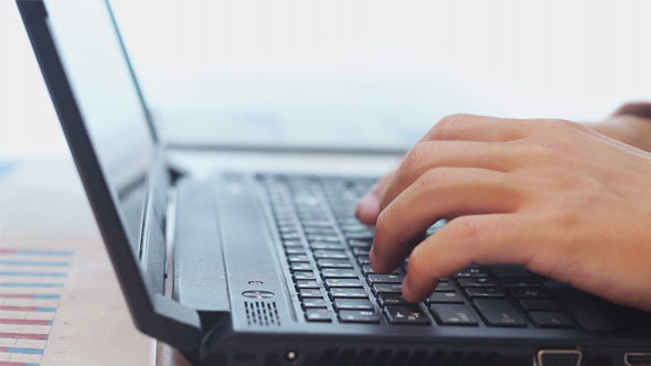 Businessman Typing on Laptop alt