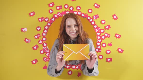 Happy Woman on an Isolated Yellow Background Holds a Lettermessage in Her Hands She Receives or