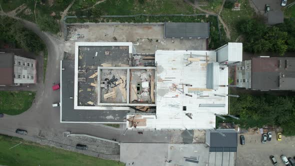 Top Aerial View of a Construction Site on the Roof of a Tall Building