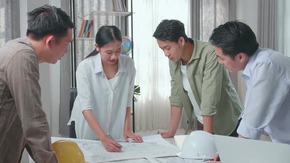 Group Of Asian Engineers Discuss About Work At The Office