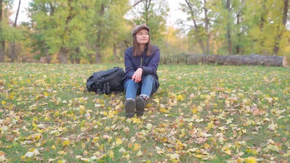 Girl Tourist on a Hike in the Autumn Forest