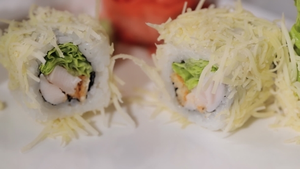 Unfolding Sushi Rolls On a Plate. Cheese, Shrimp And Rice, Hand Craftsmen Work Gloves.