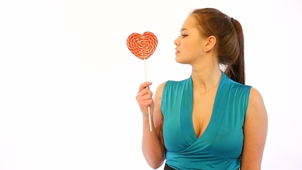 Girl Licking Heart Shaped Candy