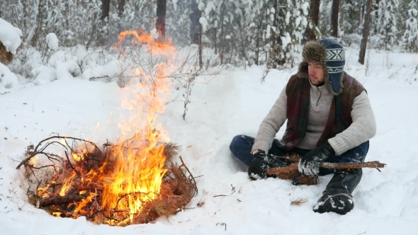 Man Set On Winter Campfire