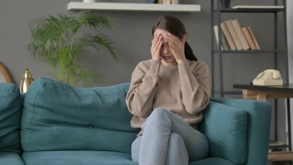 Woman Having Headache While Sitting on Sofa