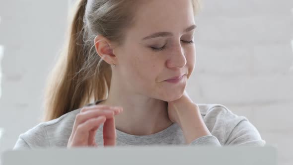 Tired Young Woman Trying to Relax at Work