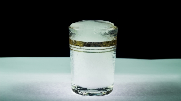 Ice Melts Into a Transparent Glass