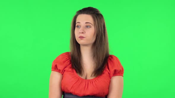 Portrait of Cute Girl Examines Something Then Fearfully Covers Her Face with Her Hands. Green Screen