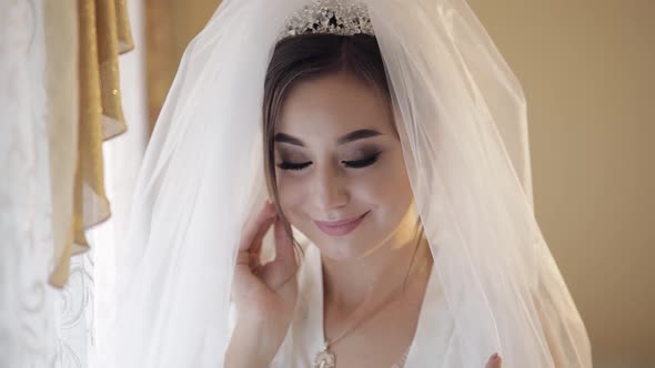 Beautiful and Lovely Bride in Night Gown and Veil. Wedding Morning. Slow Motion
