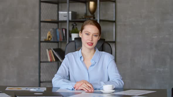 Businesswoman speaking looking at laptop computer, online conference distance