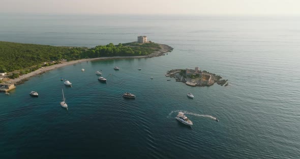 floating boats and yachts with Otocic Gospa island and fortress arza on background