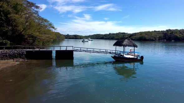 Dock with Boat in Costa Rica, Low Aerial View, Sunny Day and Blue Sky