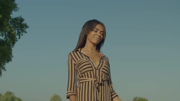 Charming African American Woman Enjoying Leisure on Summer Vacations in Nature