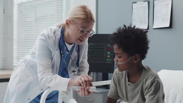 Doctor Giving Pill Organizer to Boy