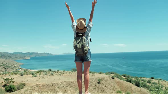 Rear View Happy Backpacker Woman Raising Hands Enjoying Amazing Landscape