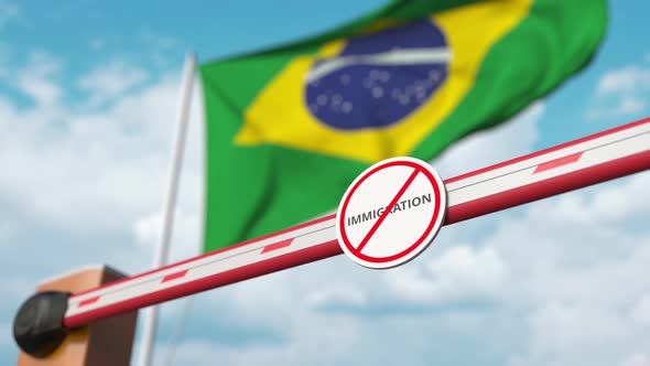 Open Boom Gate with No Immigration Sign at the Brazilian Flag