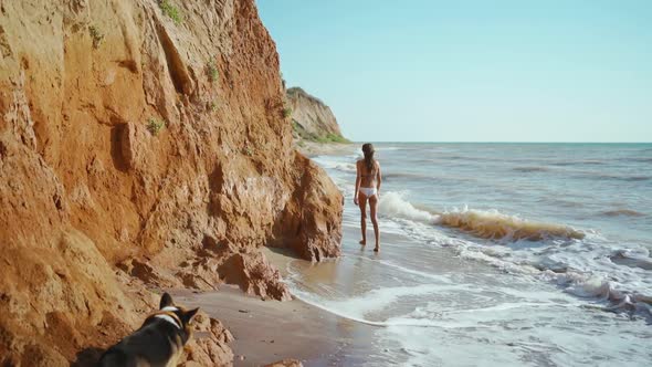 Back View Slow Motion Footage of Sexy Fitness Girl in Bikini Walking Along Sand Sea Beach with High