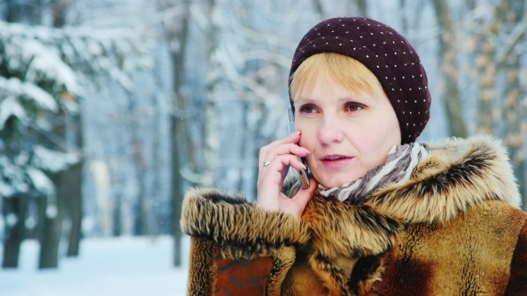 A Woman In a Fur Coat Talking On a Mobile Phone
