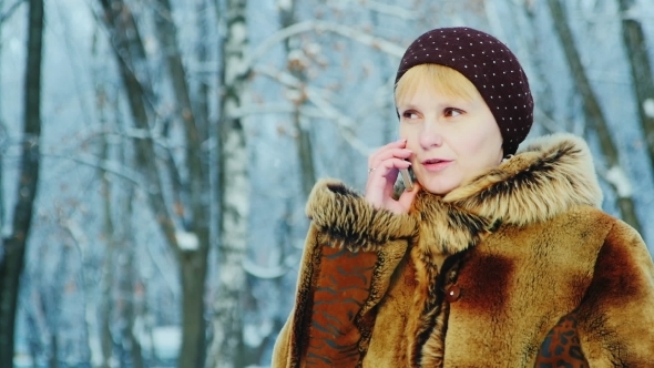 A Woman In a Fur Coat Talking On a Mobile Phone