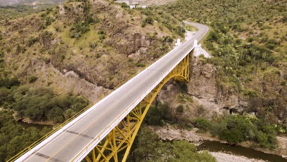 Drone video of a bridge on the highway and below it passes a river in the middle of nature in the st