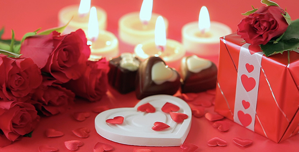 Red Roses and Chocolate Candies on Red