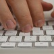 Man Typing on White Keyboard - VideoHive Item for Sale