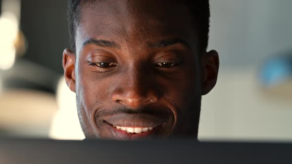 Portrait of a young man at a laptop during working hours in the office