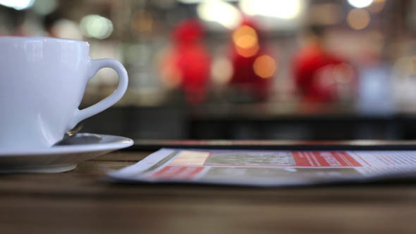 Cup and a Newspaper in a Cafe