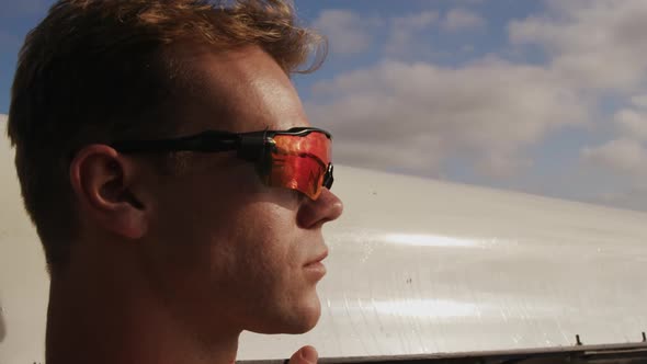 Male rower wearing sunglasses looking away