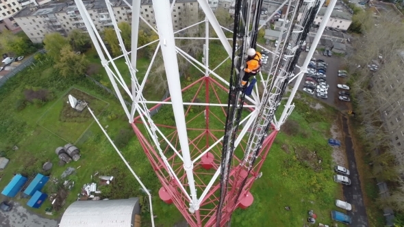 Aerial View. Workers Climb The TV Tower