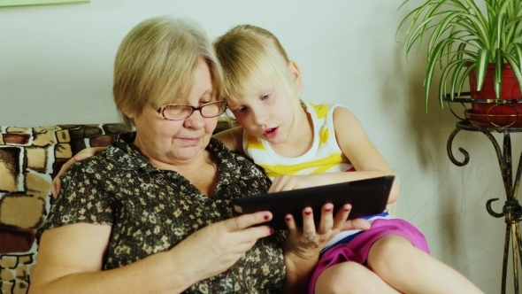 Grandmother And Granddaughter Playing Together