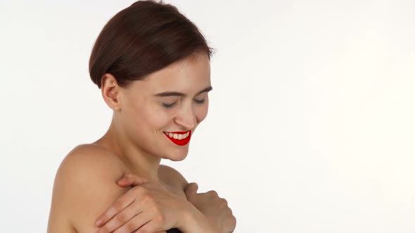 Gorgeous Naked Red Lipped Woman Laughing, Embracing Herself