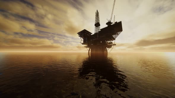 Offshore Jack Up Rig in The Middle of The Sea at Sunset Time alt