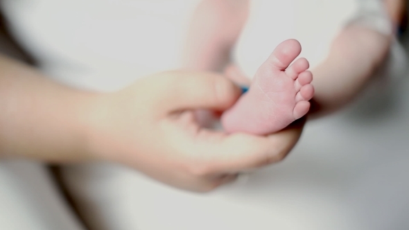 Newly Made Mother Shows Little Foot Of Her Newborn Baby