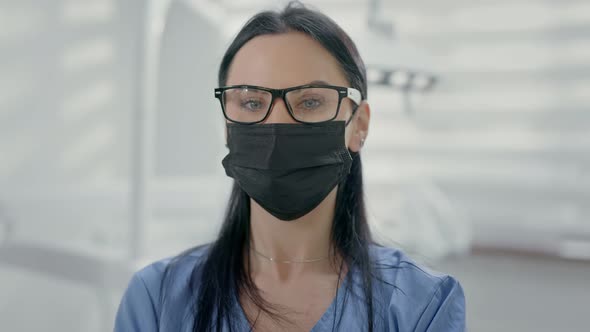 Young Female Dentist Standing In Office